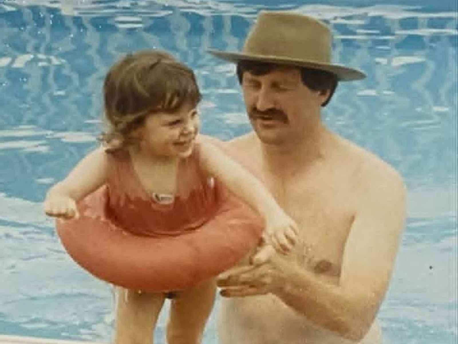 Father and daughter together at the pool