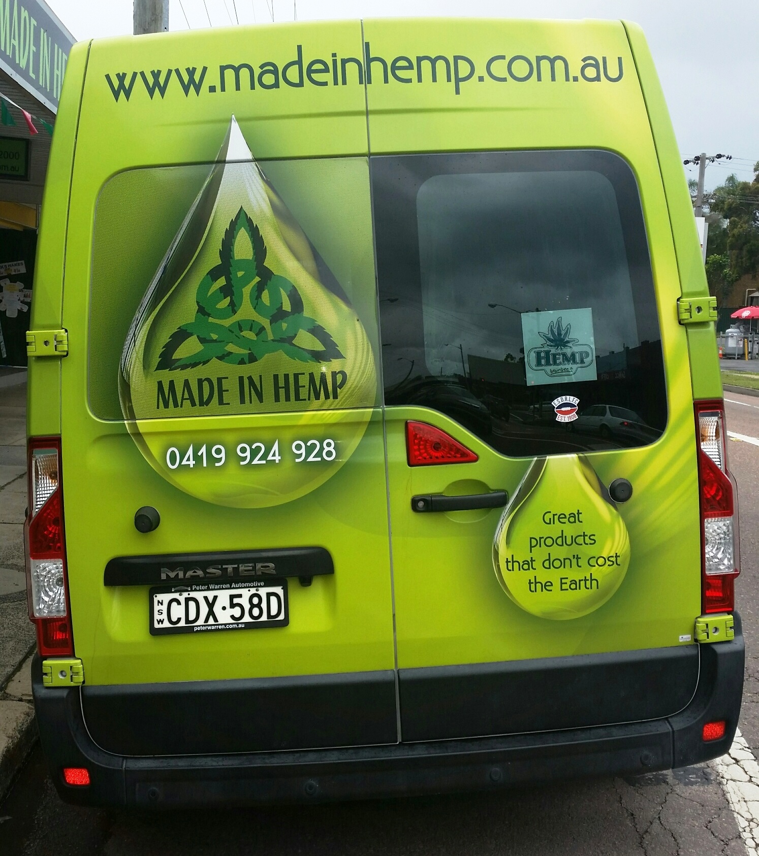 Rear view of the Made In Hemp branded van with green hemp seed oil design