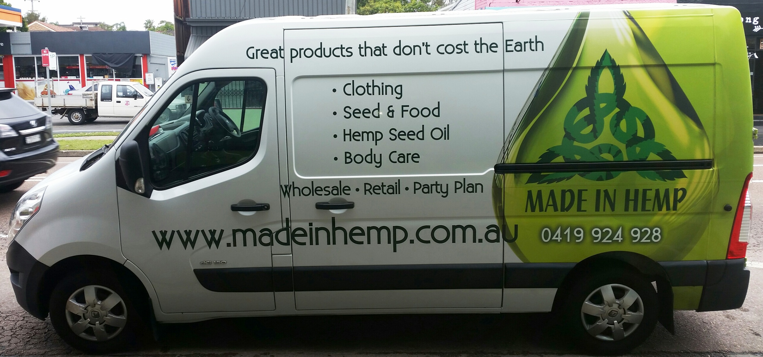 Side view of the Made In Hemp branded van advertising clothing, hemp seed foods, hemp seed oil and body care
